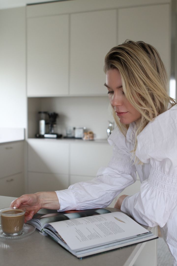 Matilda aka Moe of Sweden på Instagram läser en bok vid nyrenoverade köksön.