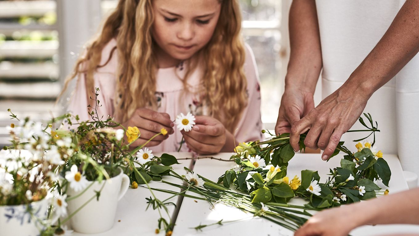 Midsommarkransen binds i växthuset med ängsblommor för ett traditionsenligt midsommarfirande. 