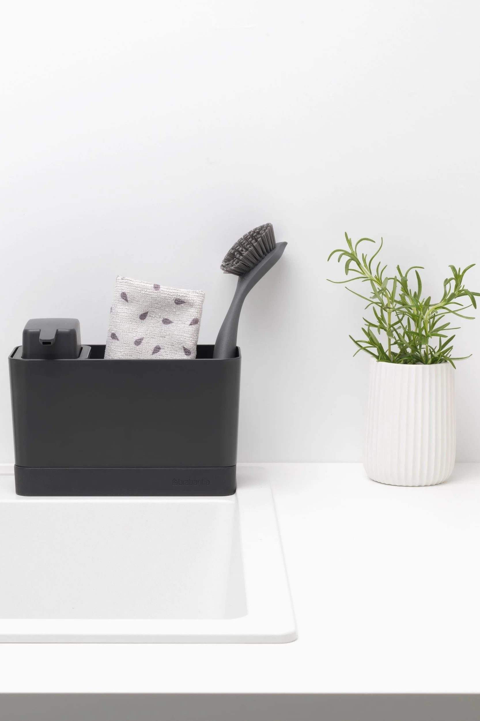 Rengör stekpannan med Brabantia diskbänksorganisatör, som innehåller en tvålpump, disktrasa och diskborste.