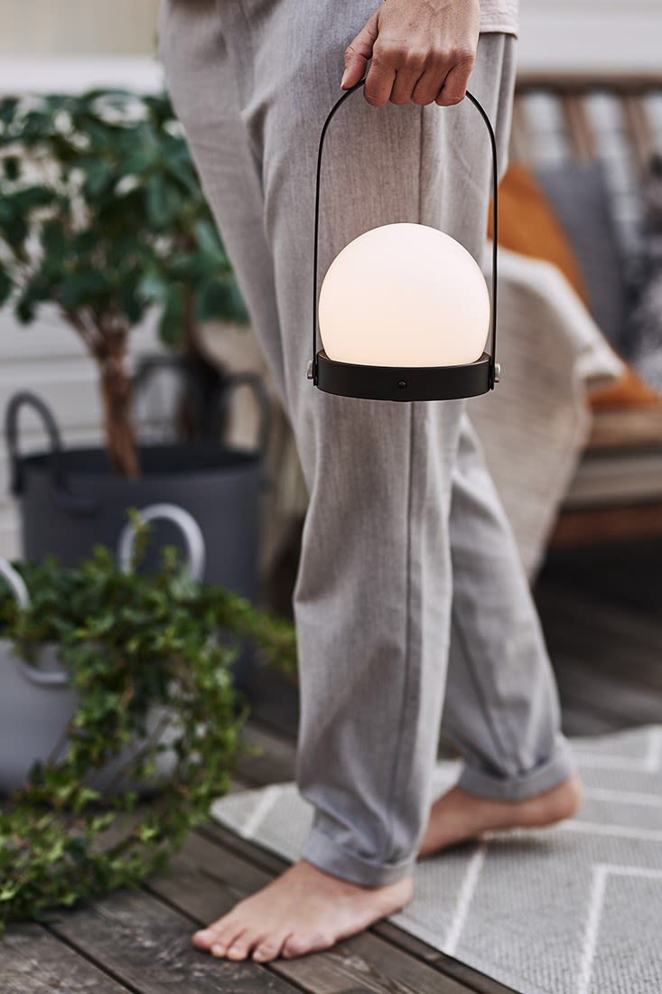 Uteplatsen lyses upp av Carrie LED-lampa från Menu – perfekt när det vankas fika på balkongen. 