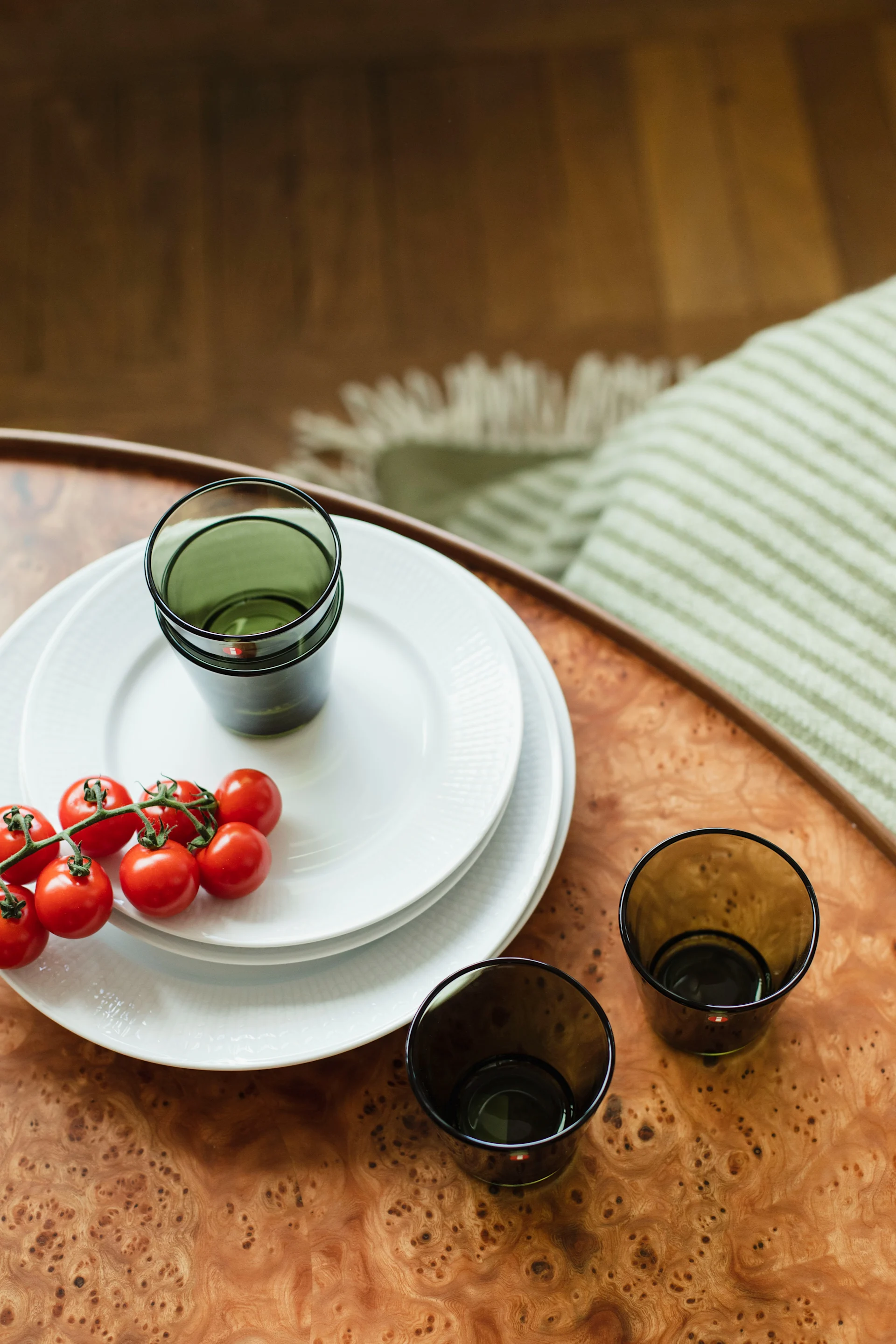 Tidlösa designklassikern Kartio dricksglas från Iittala i en härlig mossgrön färg bredvid Swedish Grace vita tallrikar från Rörstrand hemma hos Ebba Kleberg von Sydow.