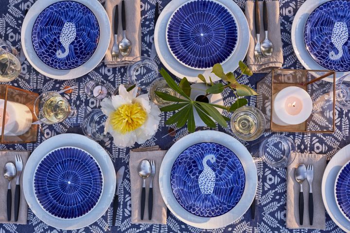 Duka till midsommar i bohemisk stil med blåvitt porslin från Götefors porslin, retrobestick från Gense och ljuslyktor på bordet. 