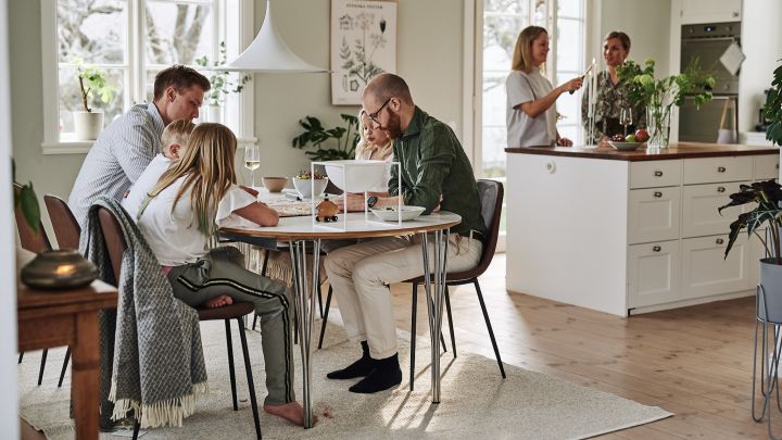 En ljus matplats i skandinavisk stil med ljusa väggar och öppna ytor att underhålla gäster i. 