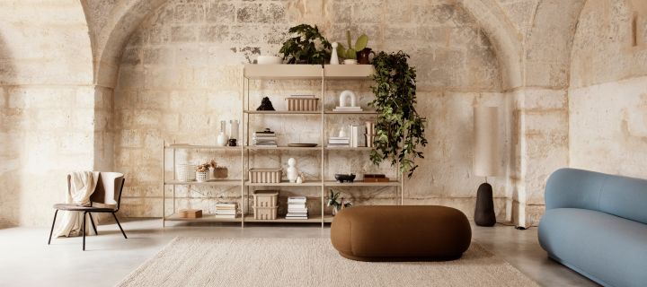 Beigt vardagsrum med stenväggar och runda möbler från Ferm Living är som inredning 2021 kommer se ut. 