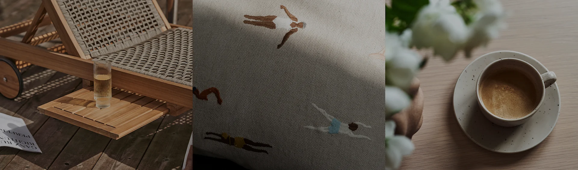 En solstol med en dryck, en broderad kudde med simmare och en kaffekopp med vita blommor.