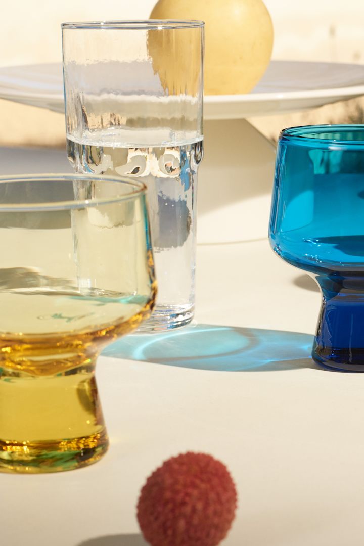 Den nya Solare-kollektionen från Iittala, här ser du de gula, blå och klara glasögonen i kollektionen skina i solskenet. 