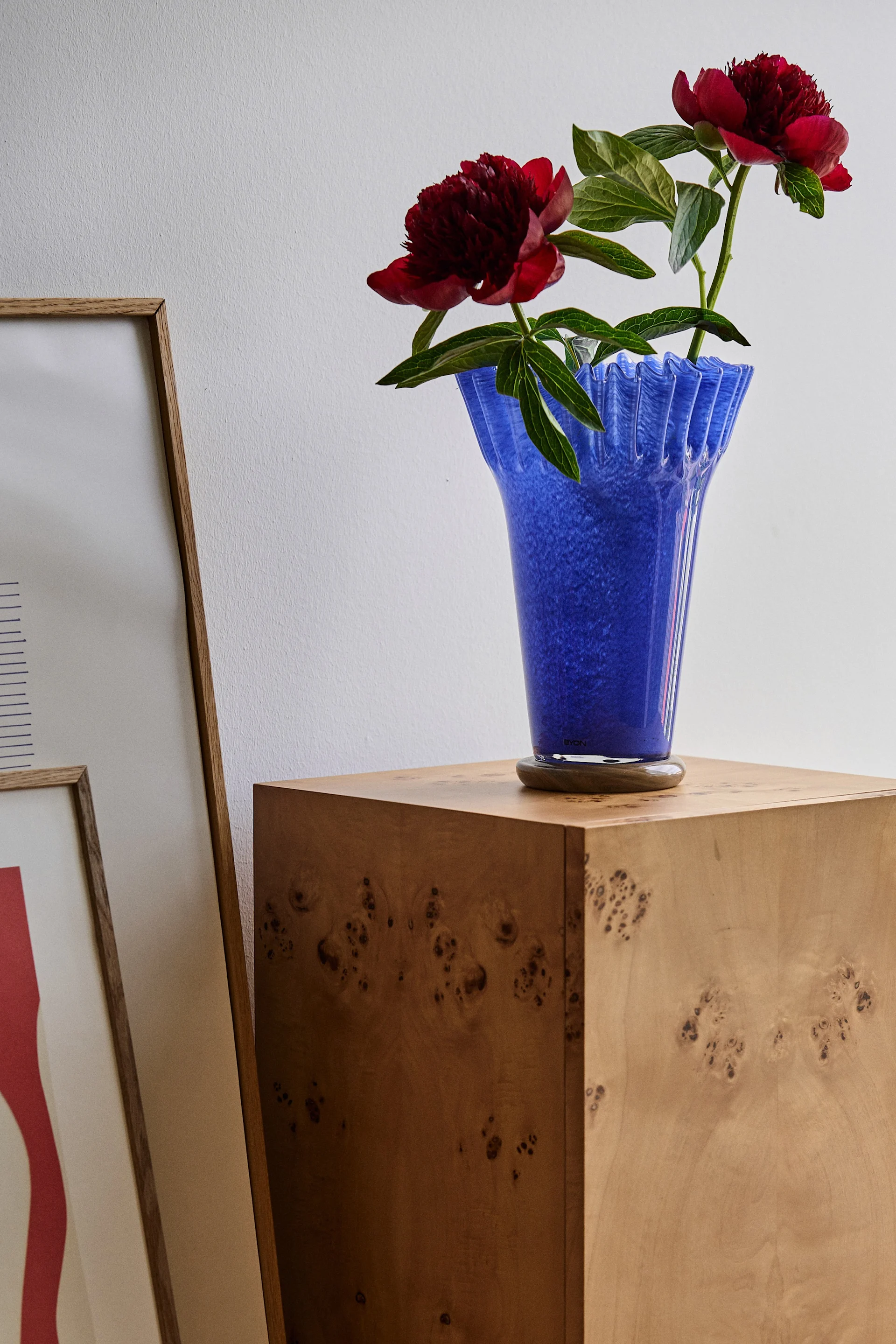 Blå, hög vas från BYON med röda pioner i - ett fint tips på mors dag present. 
