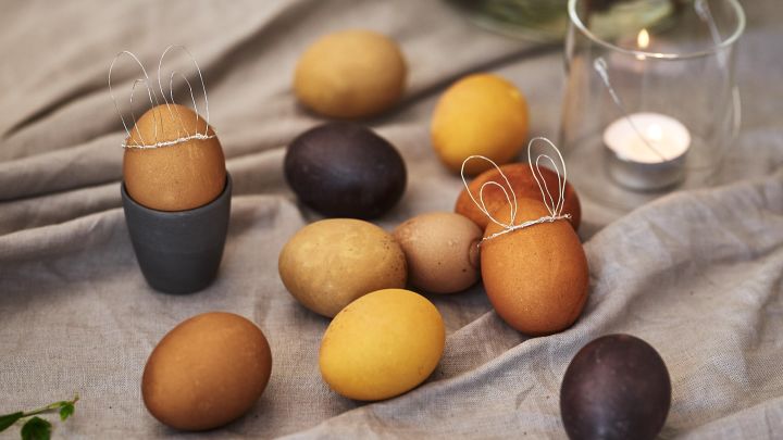 Färga ägg naturligt med råvaror som gurkmeja och kaffe för påskägg i diskreta nyanser av gult och brunt på påskdukningen. 