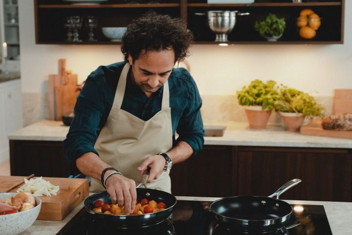 Kocken Markus Aujalay lagar mat i sitt kök med stekpannor från sitt egna varumärke med matlagningsprodukter i reportaget med Nordic Nest. 