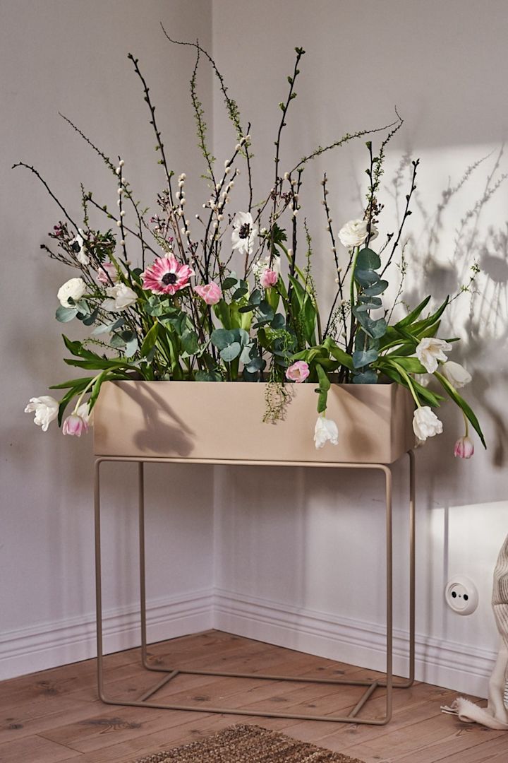 Ett vackert arrangemang med färska blommor som ser ut som en inomhusrabatt i ferm LIVINGs ikoniska växtlåda. 