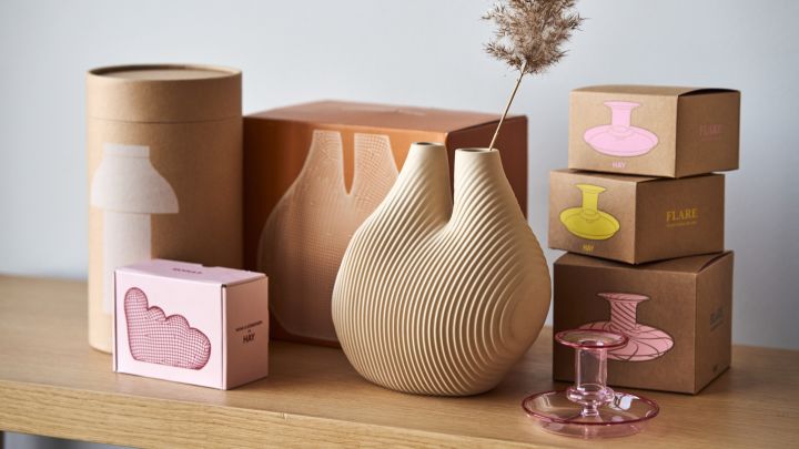 Fina förpackningar för HAYs produkter bredvid W&S Chamber vas i Light beige och Flare Stripe ljusstake i rosa.