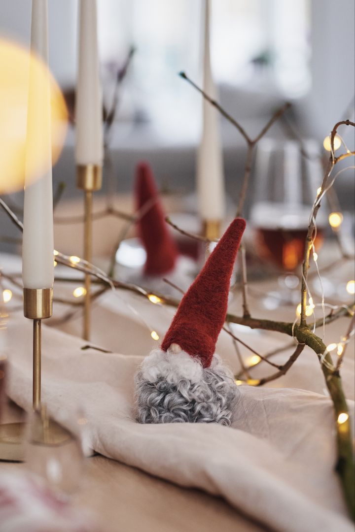 Tomte i ull och ljus i mässingsljusstakar blir vackra dekorationer som sprider stämning på juldukningen. 